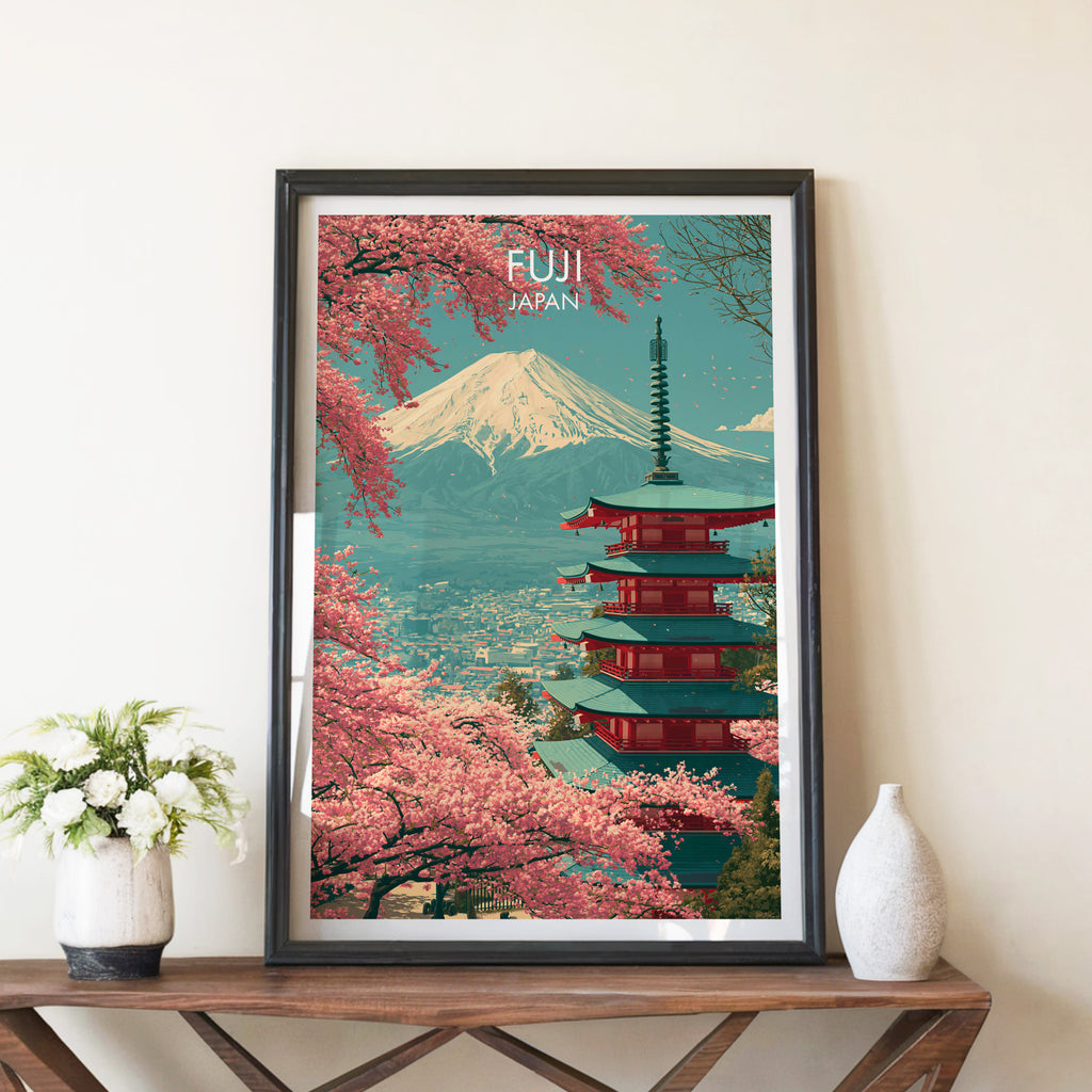 Mount Fuji Japan travel poster in a black frame on a wooden console table with white flowers