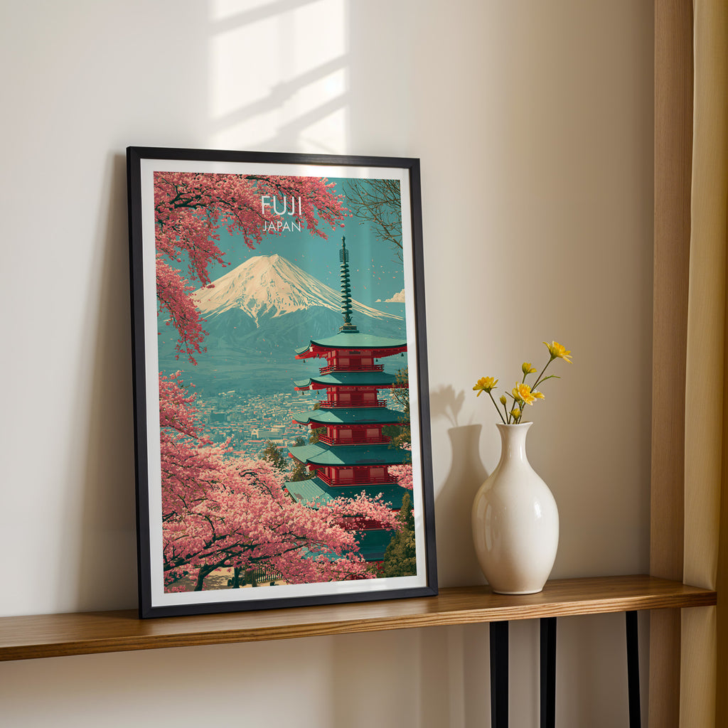 Black framed Mount Fuji Japan print on a narrow hallway console in sunlight, styled with yellow flowers