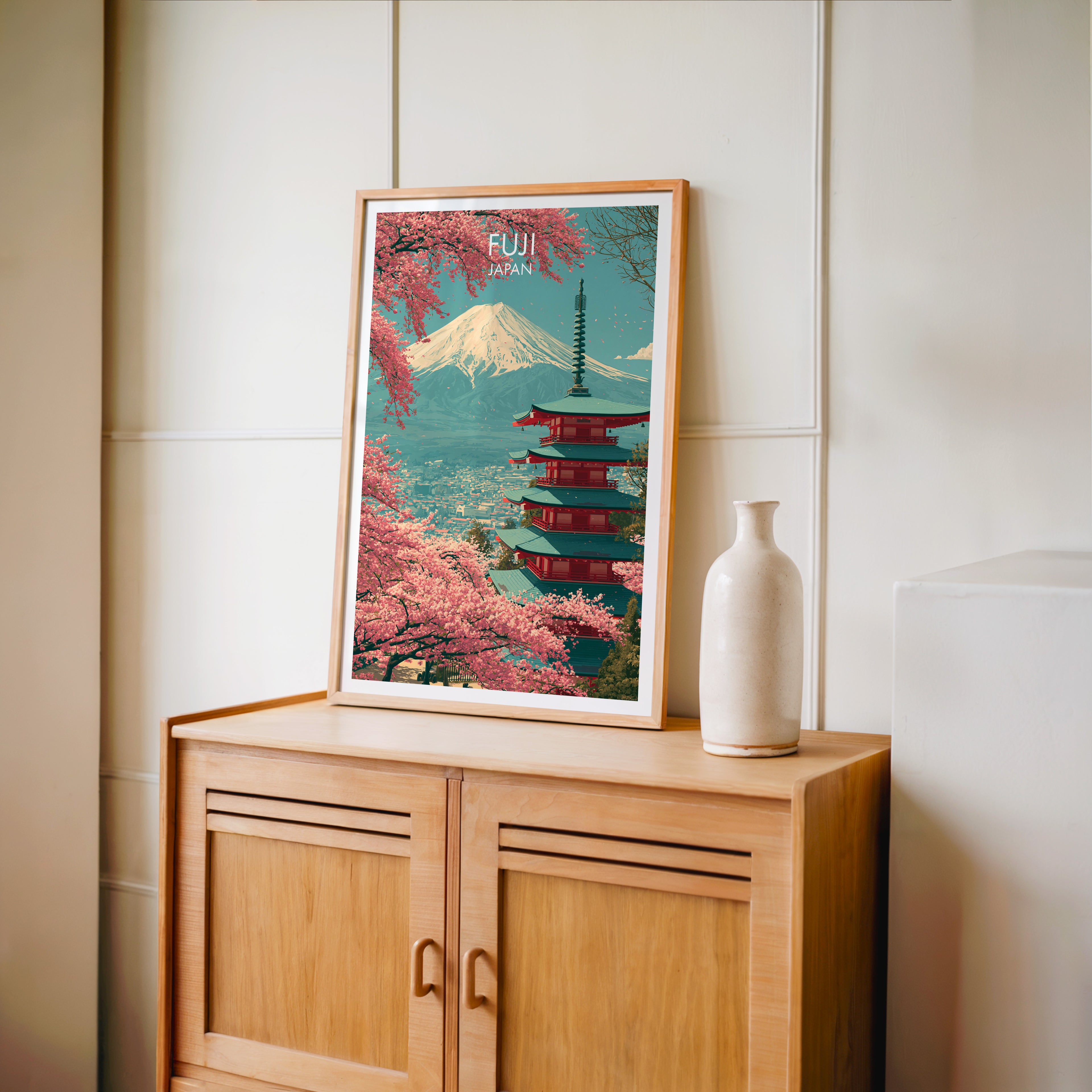 Small Mount Fuji Japan travel poster in an oak frame on a mid-century sideboard with a ceramic vase