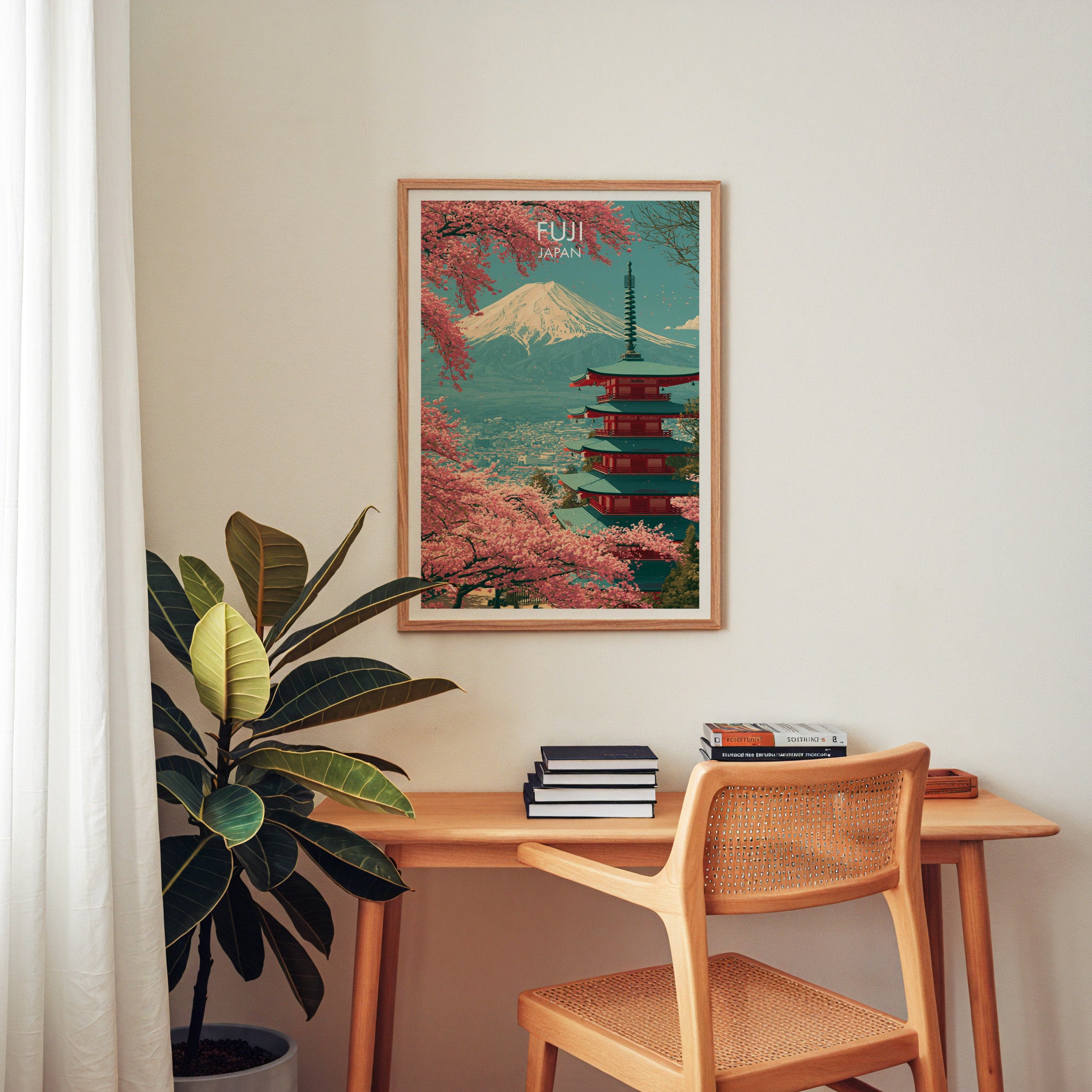 Mount Fuji Japan wall art above a wooden home office desk with a rattan chair and books