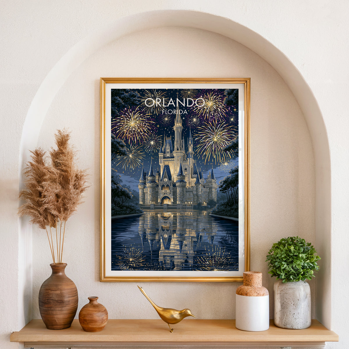 Orlando castle print in a gold frame set in an arched wall niche with pampas grass and a brass bird