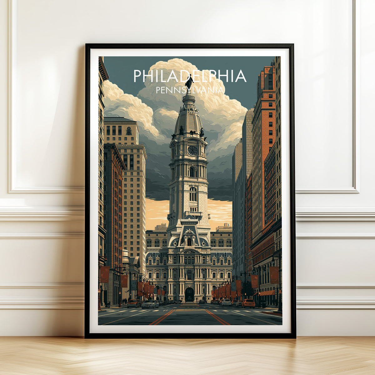 Philadelphia City Hall print in a black frame leaning on a white panelled wall above a wood floor