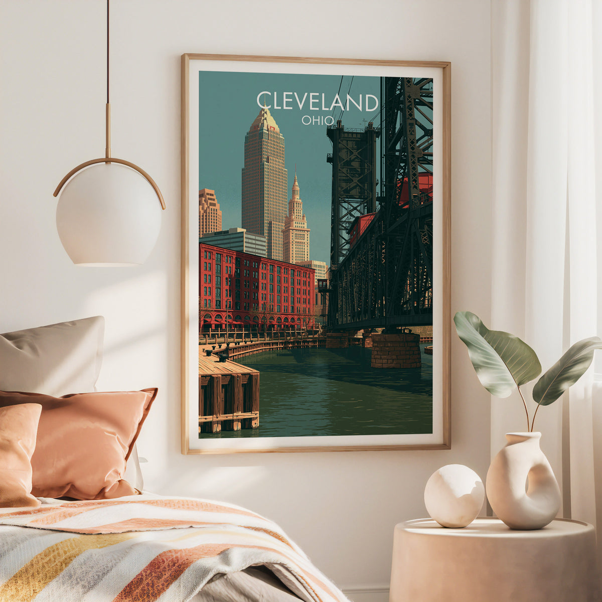 Cleveland canvas art in a large oak frame above a bed with a rust throw and a brass globe pendant.