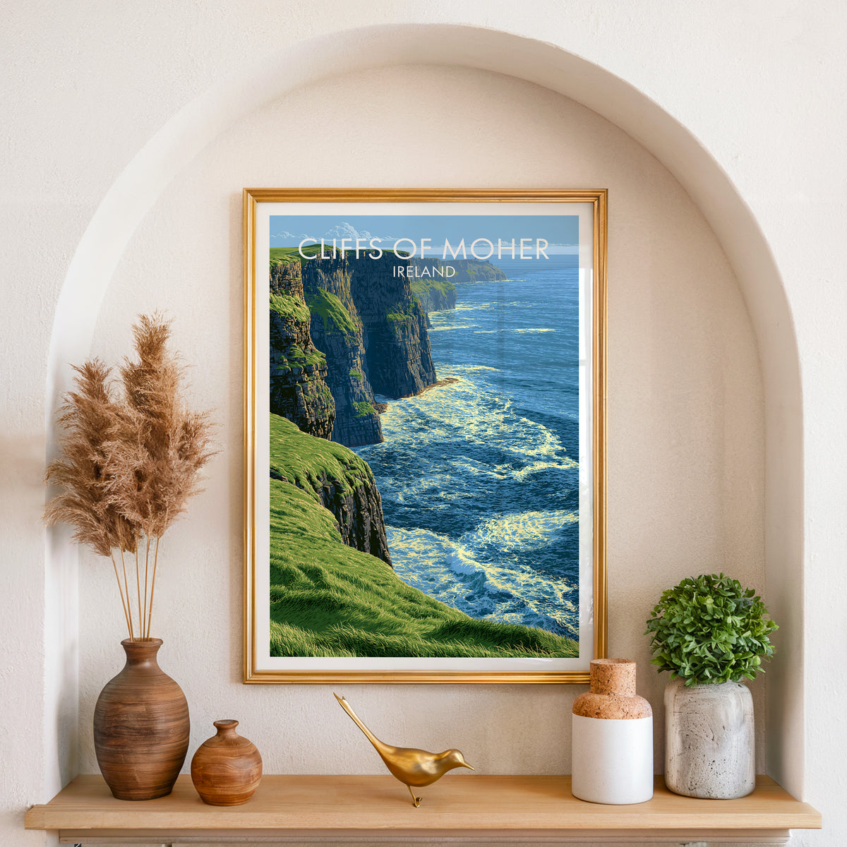 Cliffs of Moher poster, gold frame in an arched wall niche above pampas grass in a clay vase