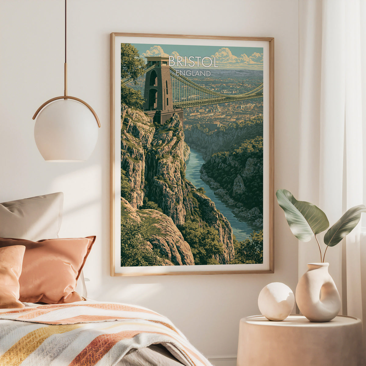 Clifton Bridge Bristol wall art, large oak frame above a bed with rust bedding and a brass globe pendant