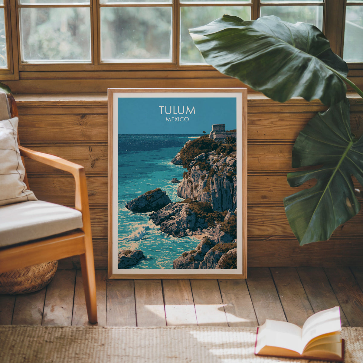 Clifftop stone building print in an oak frame on a pine cabin wall with a wooden armchair and jute rug.