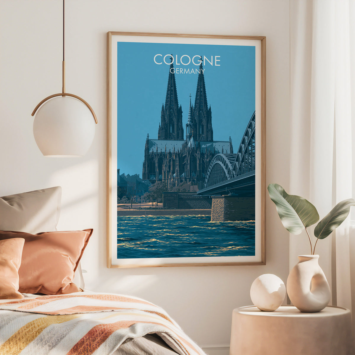 Cologne Germany wall art, large oak frame above a bed with rust bedding and a brass globe pendant