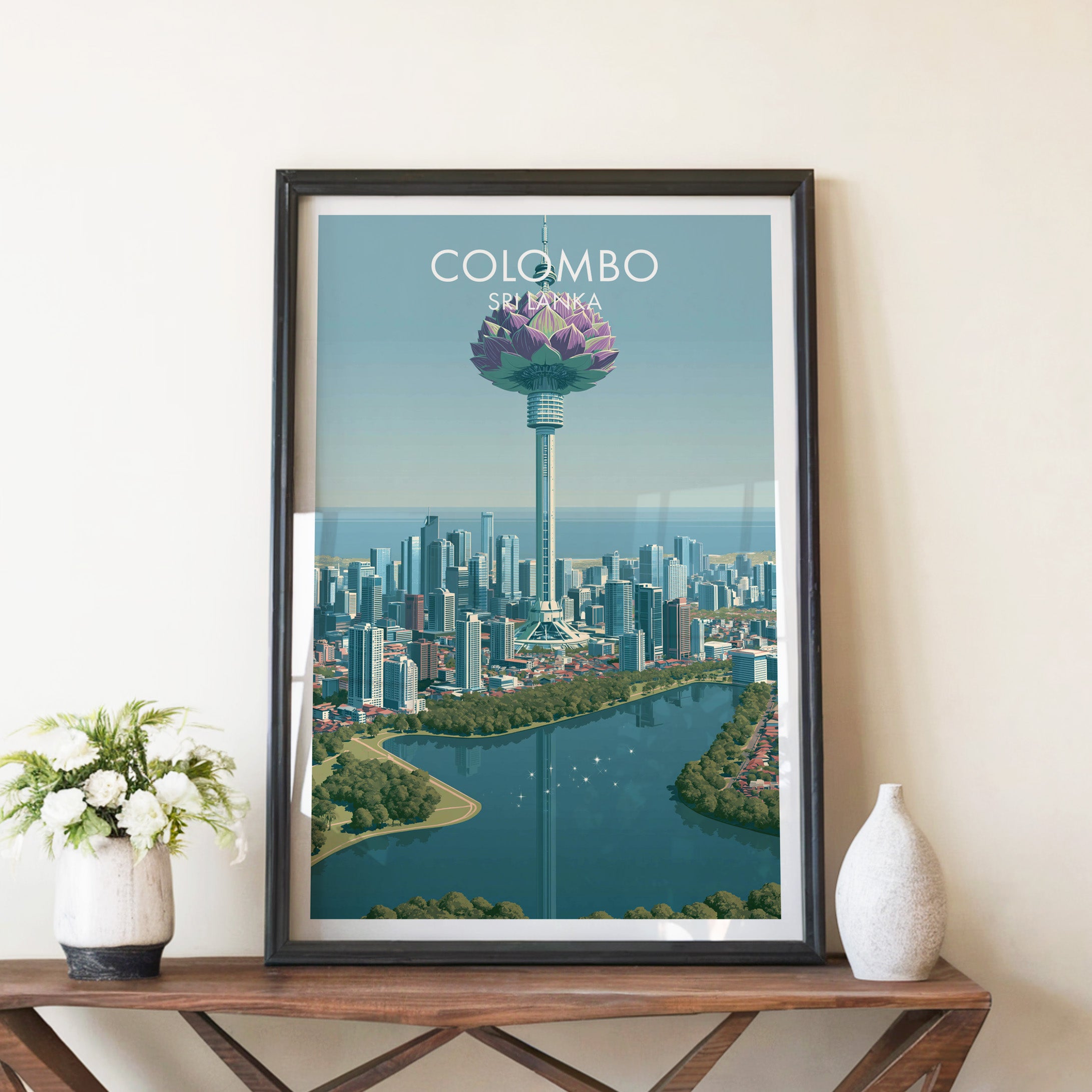 Colombo Sri Lanka travel poster in a black frame on a wooden console table with white flowers