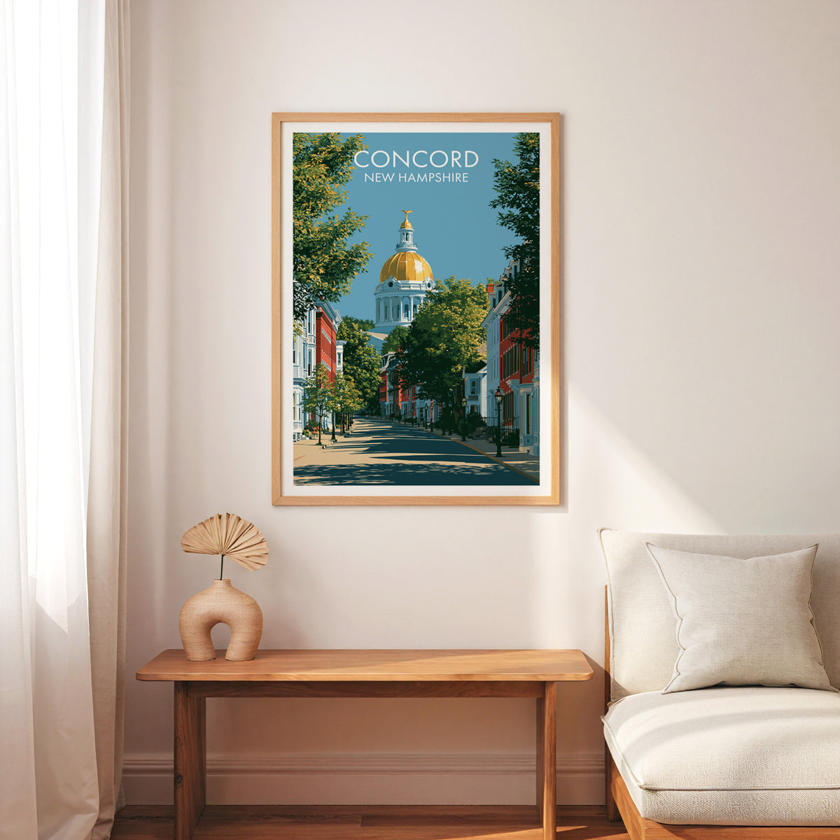 Concord Main Street wall art in an oak frame above a slim wood bench and cream armchair