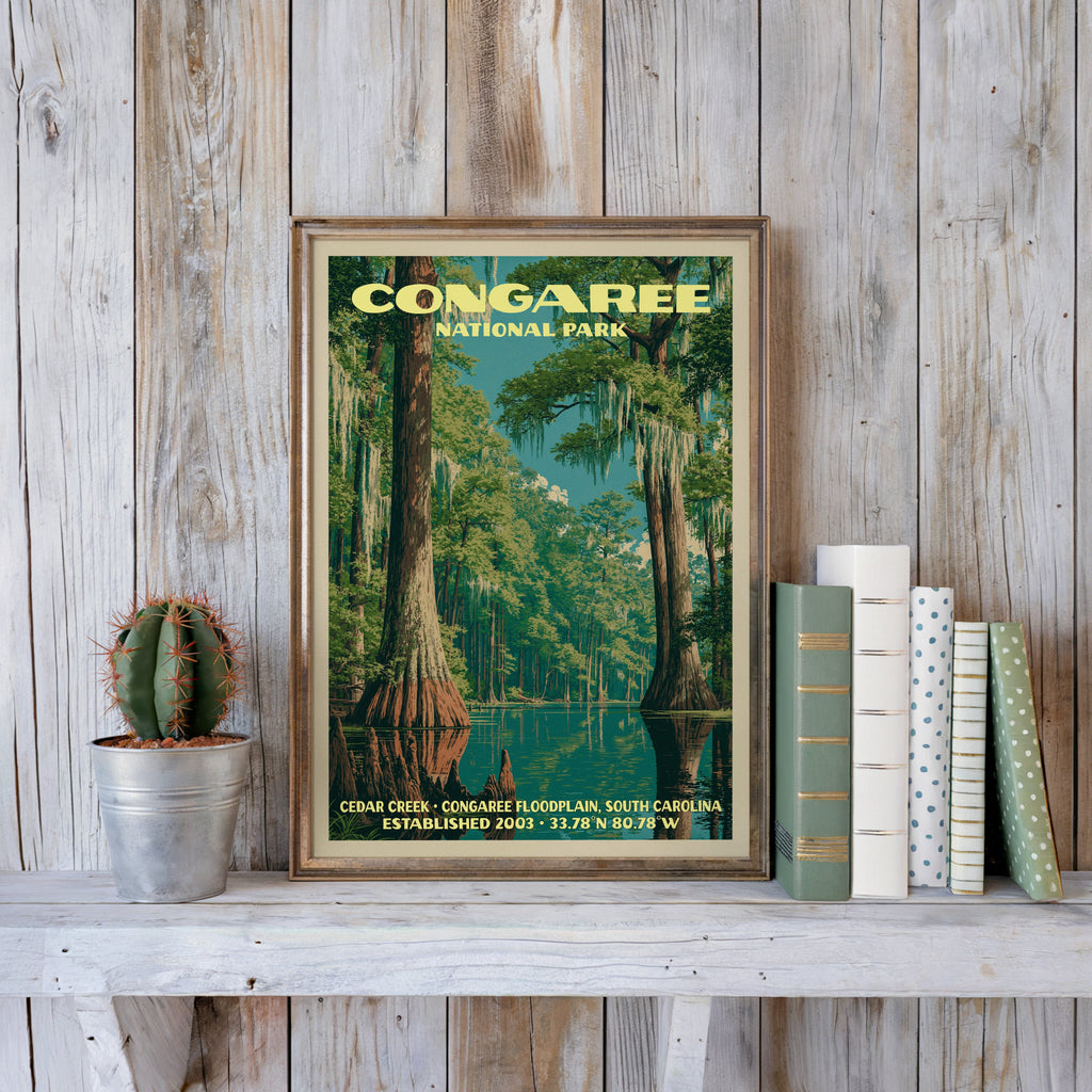 Congaree vintage poster in a slim gold frame on a whitewashed plank wall beside a cactus and pastel books