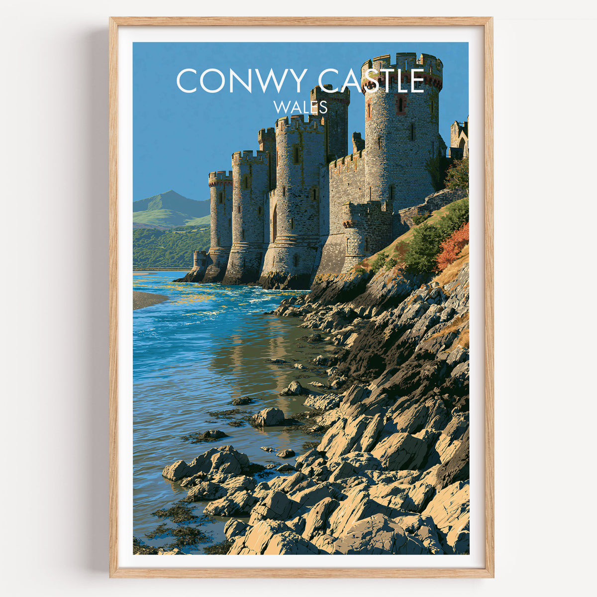 Conwy Castle travel poster, light oak frame on a plain white wall