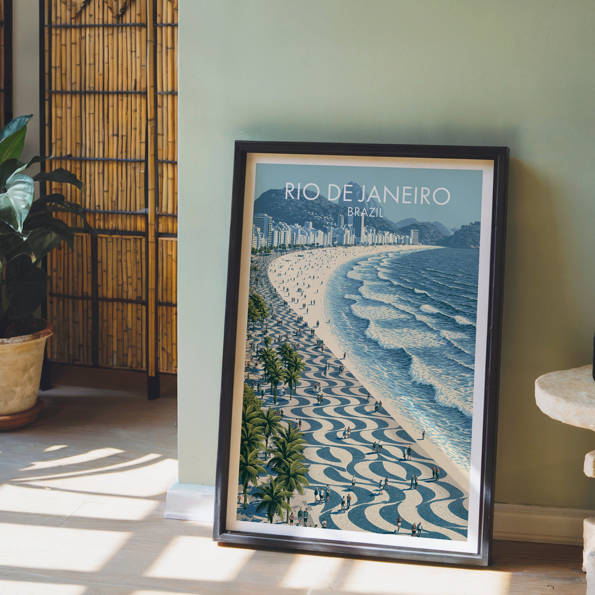 Palm-lined boardwalk print in a dark brown frame on a pale wood floor by a sage wall, bamboo screen and terracotta pot