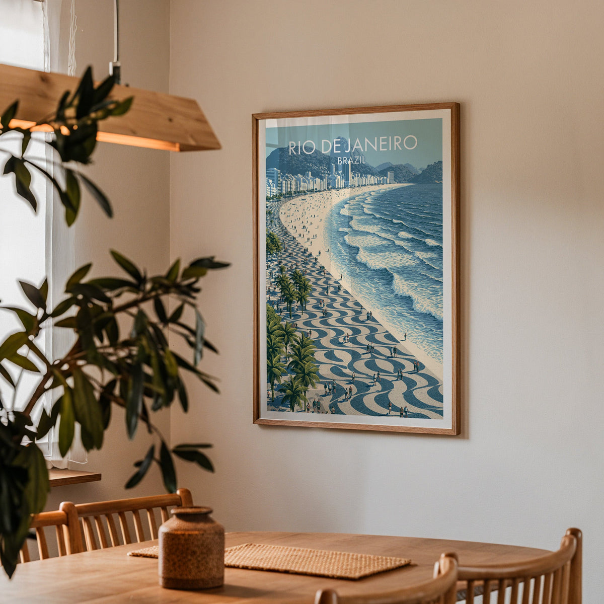 Copacabana Beach poster in an oak frame in a dining corner with a wood table, slat chairs and a pendant lamp