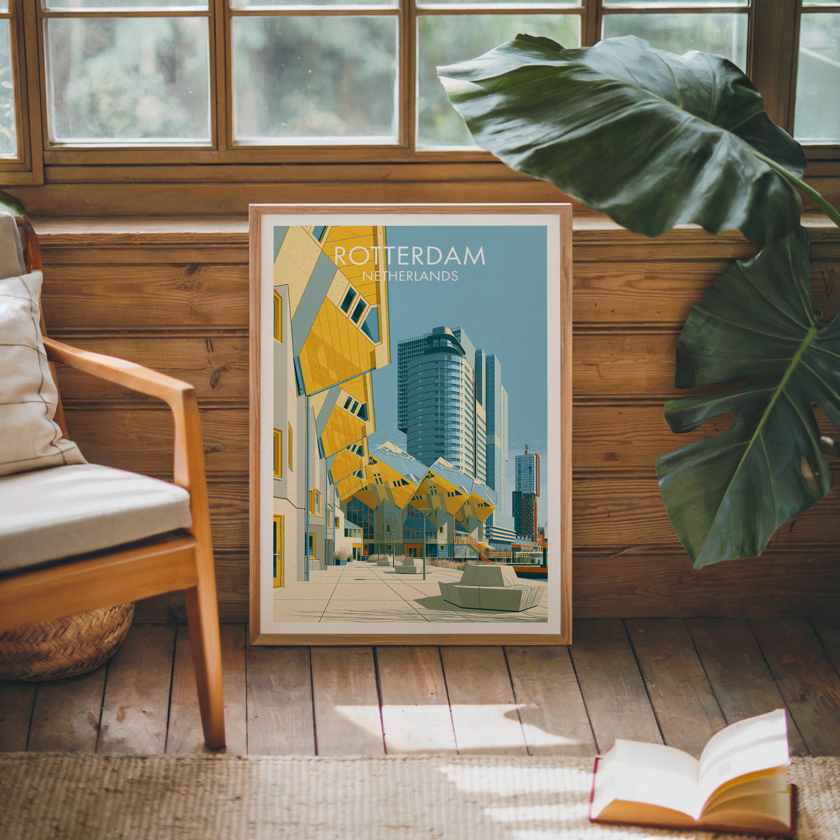 Cube Houses Rotterdam poster, oak frame leaning on a wood-panelled sunroom wall by a mid-century armchair