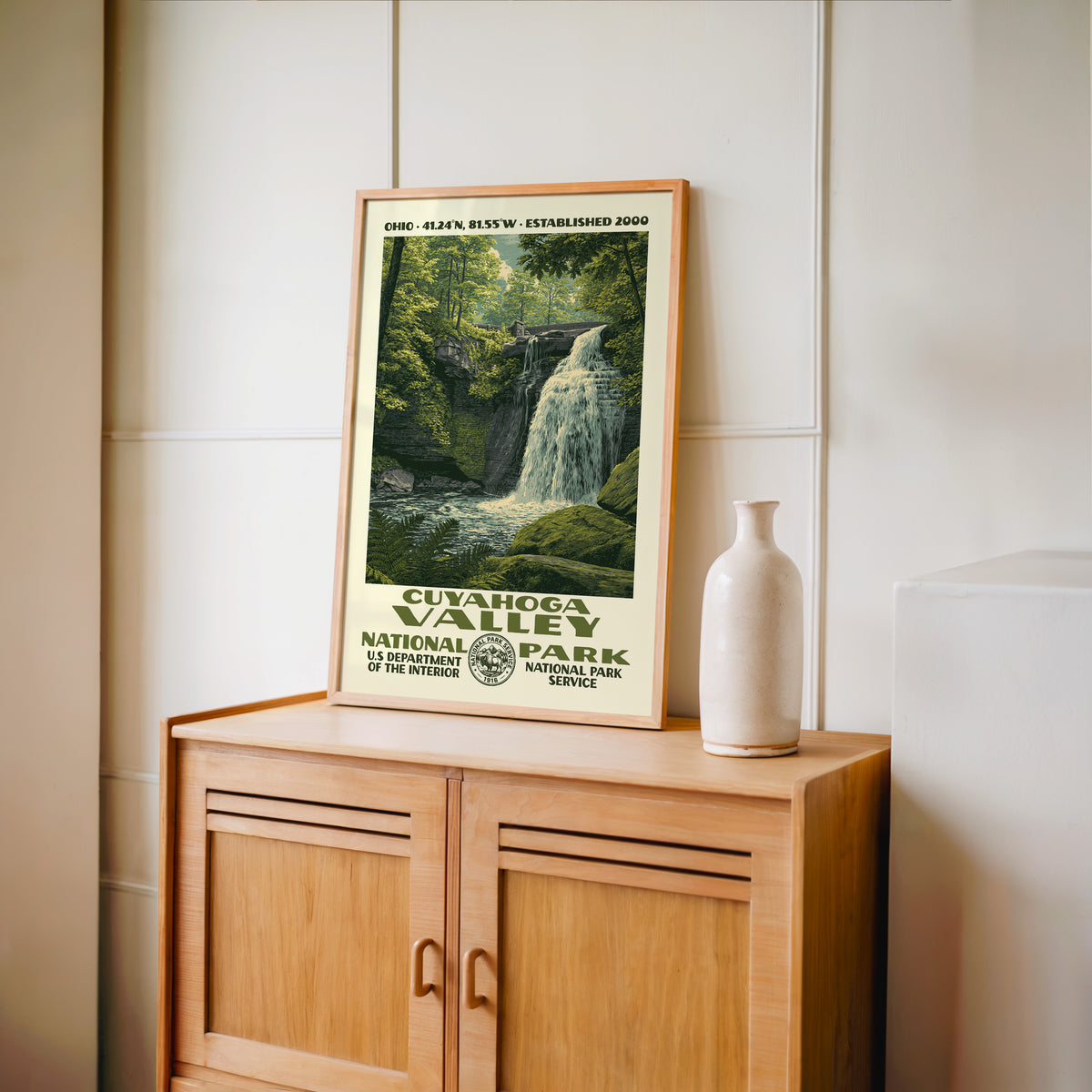 Cuyahoga Valley National Park WPA print framed in light oak on a wooden sideboard with a ceramic vase