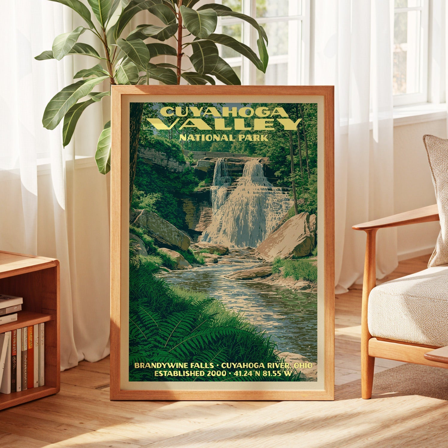 Cuyahoga Valley vintage poster in oak, leaning by a sunlit window with sheer curtains and a bookshelf
