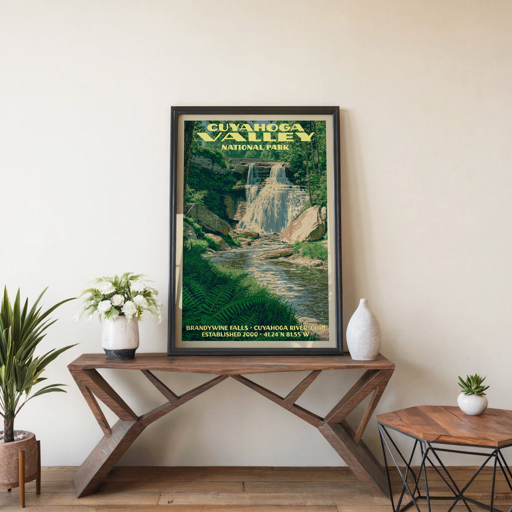 Cuyahoga Valley Brandywine Falls wall art in black, leaning on a walnut console with white anemones