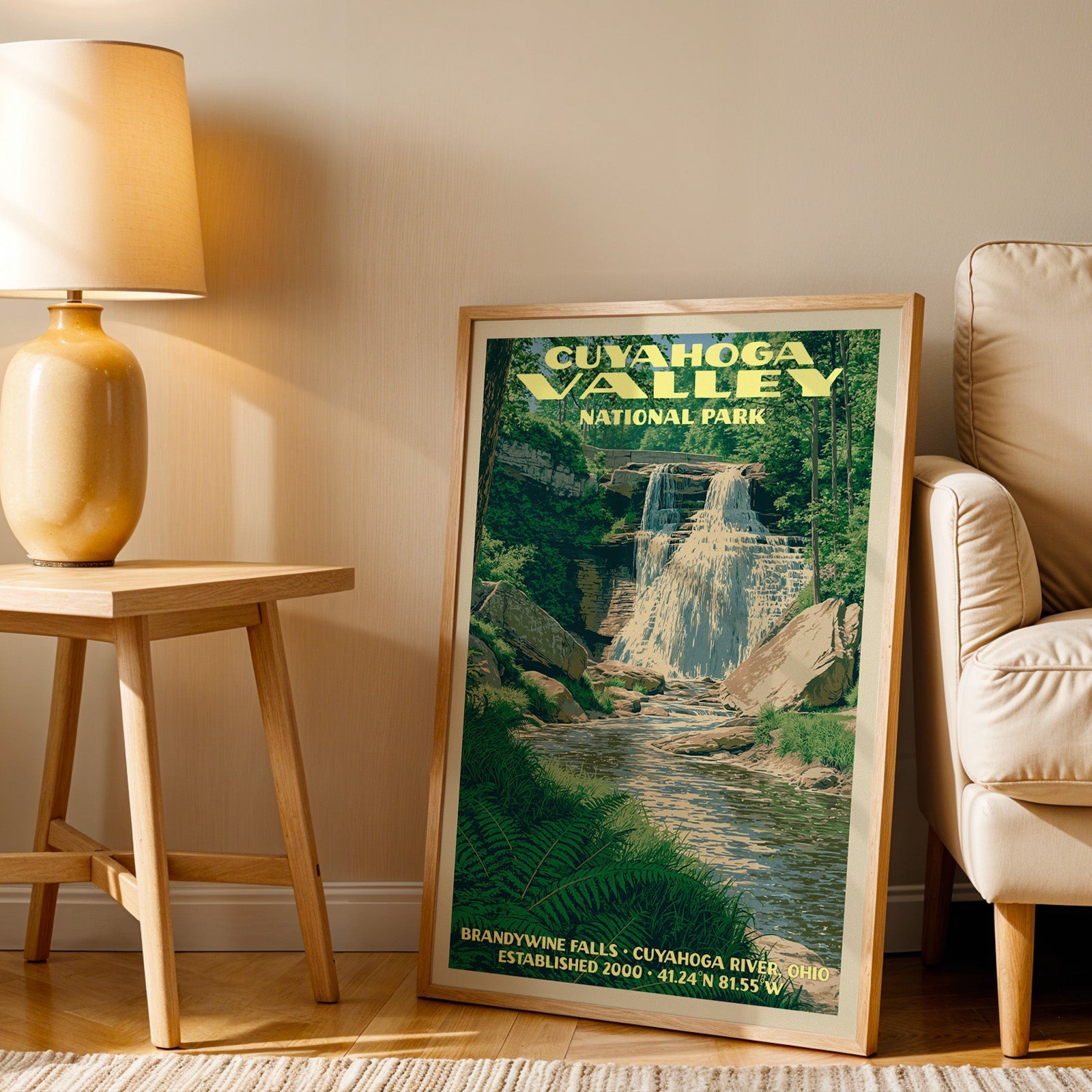 Cuyahoga Valley Brandywine Falls wall art in oak, leaning by an armchair and a table with an ochre lamp
