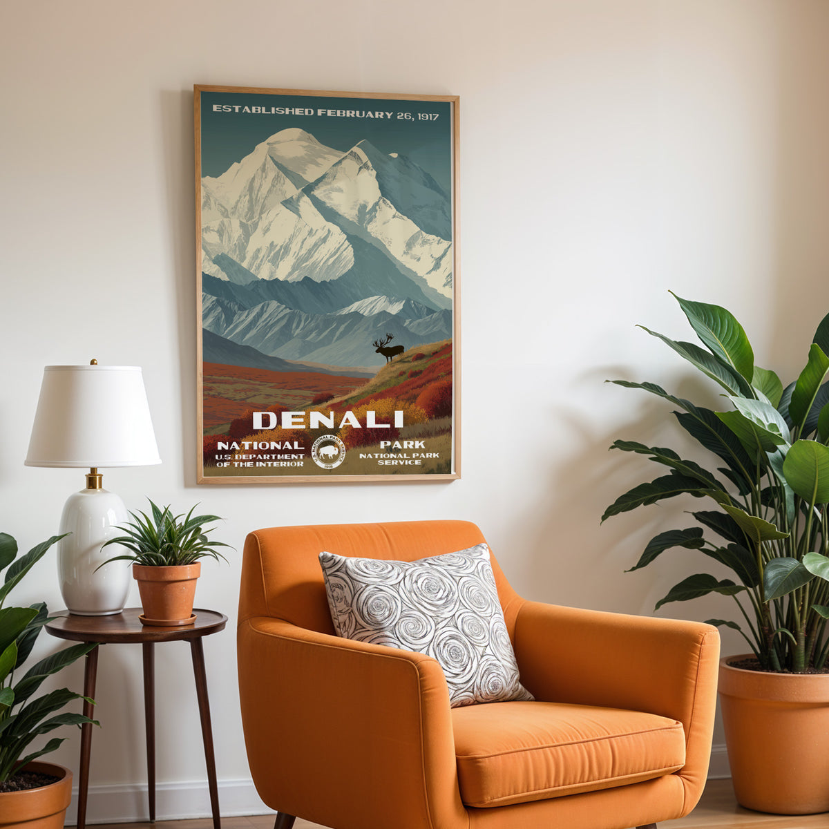Denali National Park vintage print hung above a burnt-orange armchair and side table