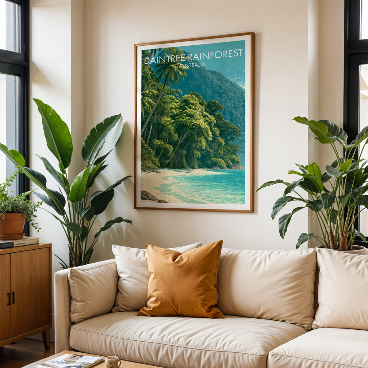 Daintree Rainforest poster in an oak frame above a cream sofa with a burnt-orange cushion and tropical plants