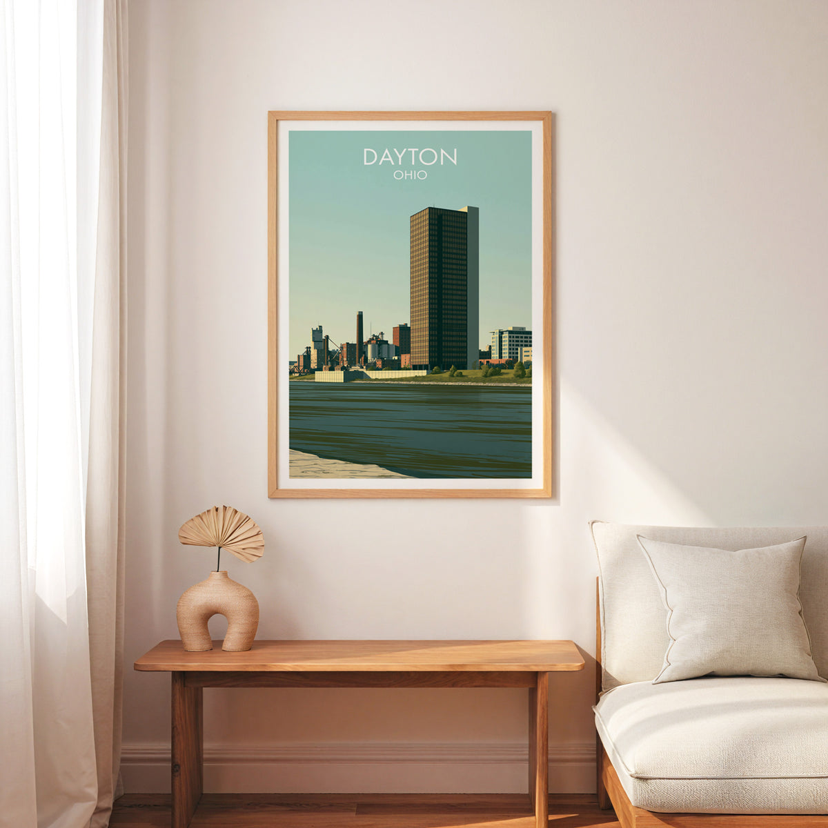 Dayton Ohio wall art in an oak frame above a slim wood bench and a cream armchair