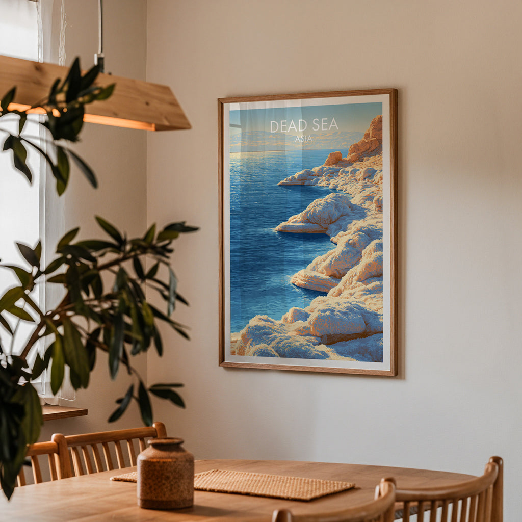 Framed Dead Sea Middle East print on a dining room wall above an oak table in warm afternoon light
