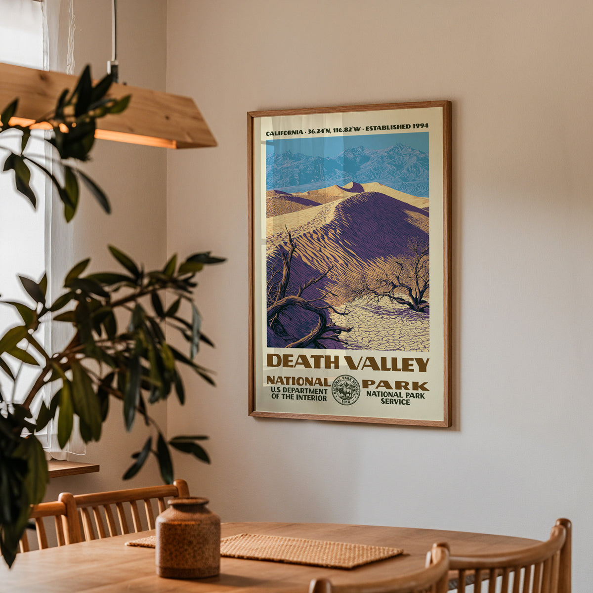 Death Valley National Park vintage travel print hung above a wooden dining table under a pendant lamp