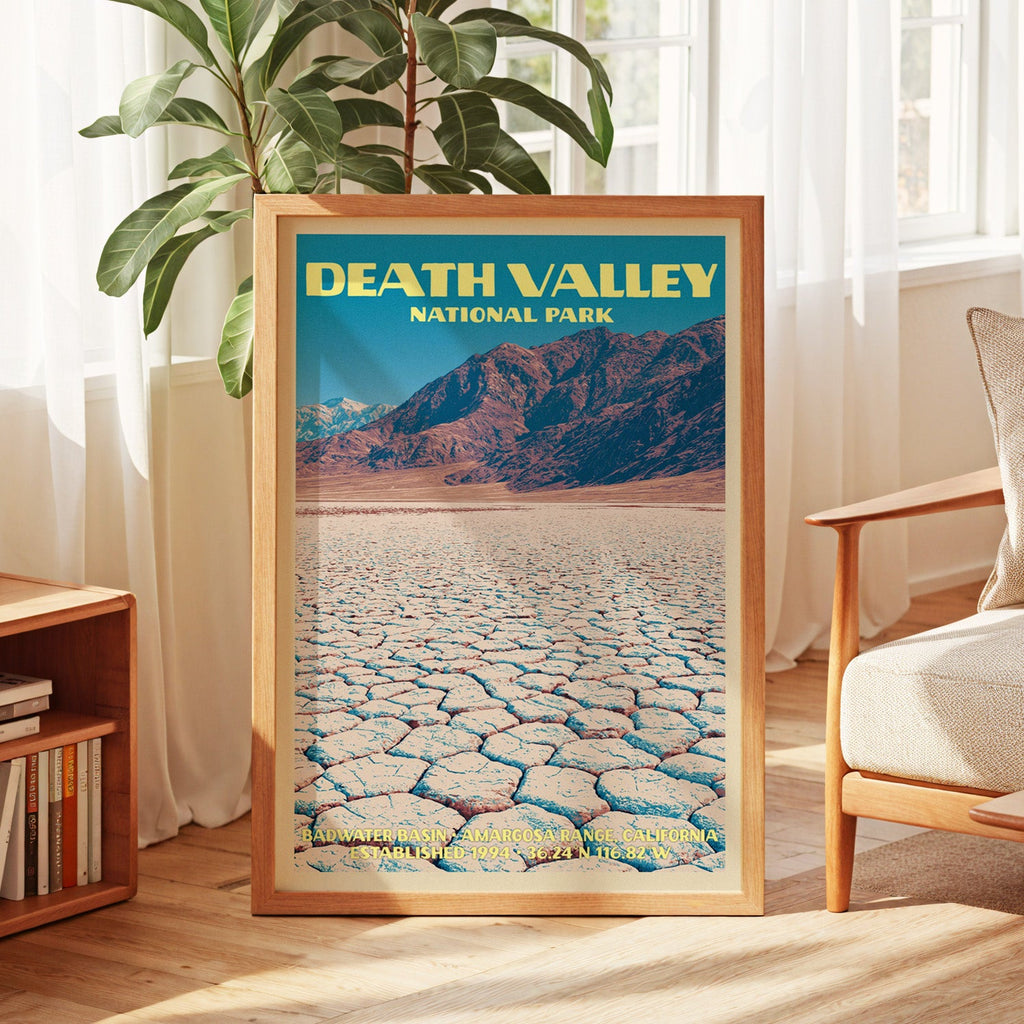 Death Valley vintage poster in oak, leaning by a sunlit window with sheer curtains and a low bookshelf