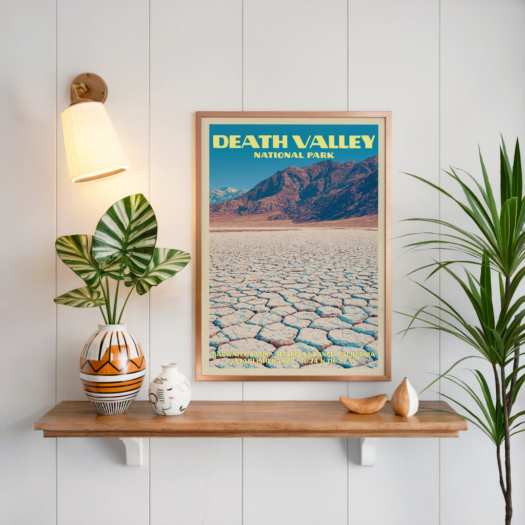 Badwater Basin Death Valley print framed on white panelling above an oak shelf with a patterned vase and sconce