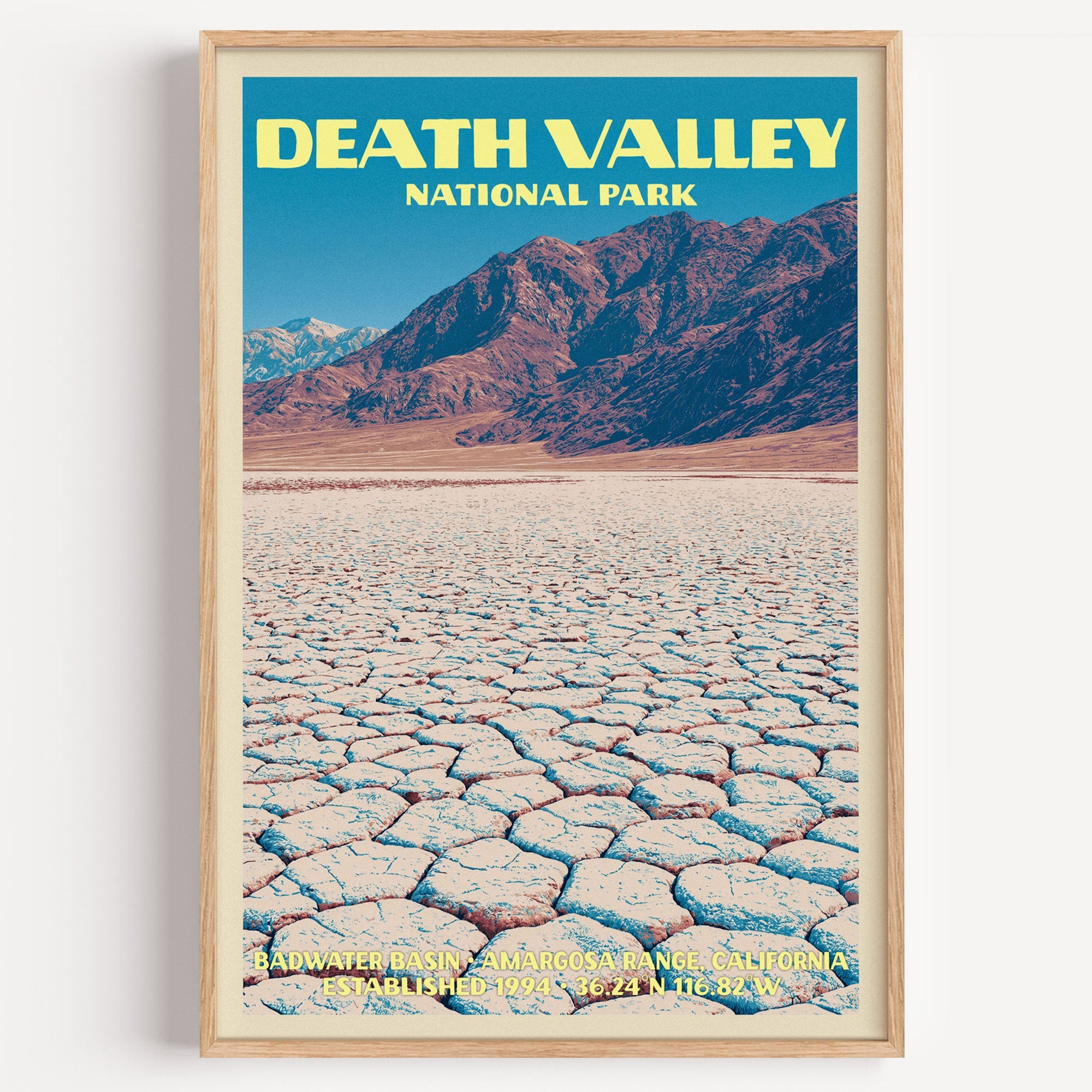 Badwater Basin Death Valley vintage poster in a light oak frame on a plain white wall