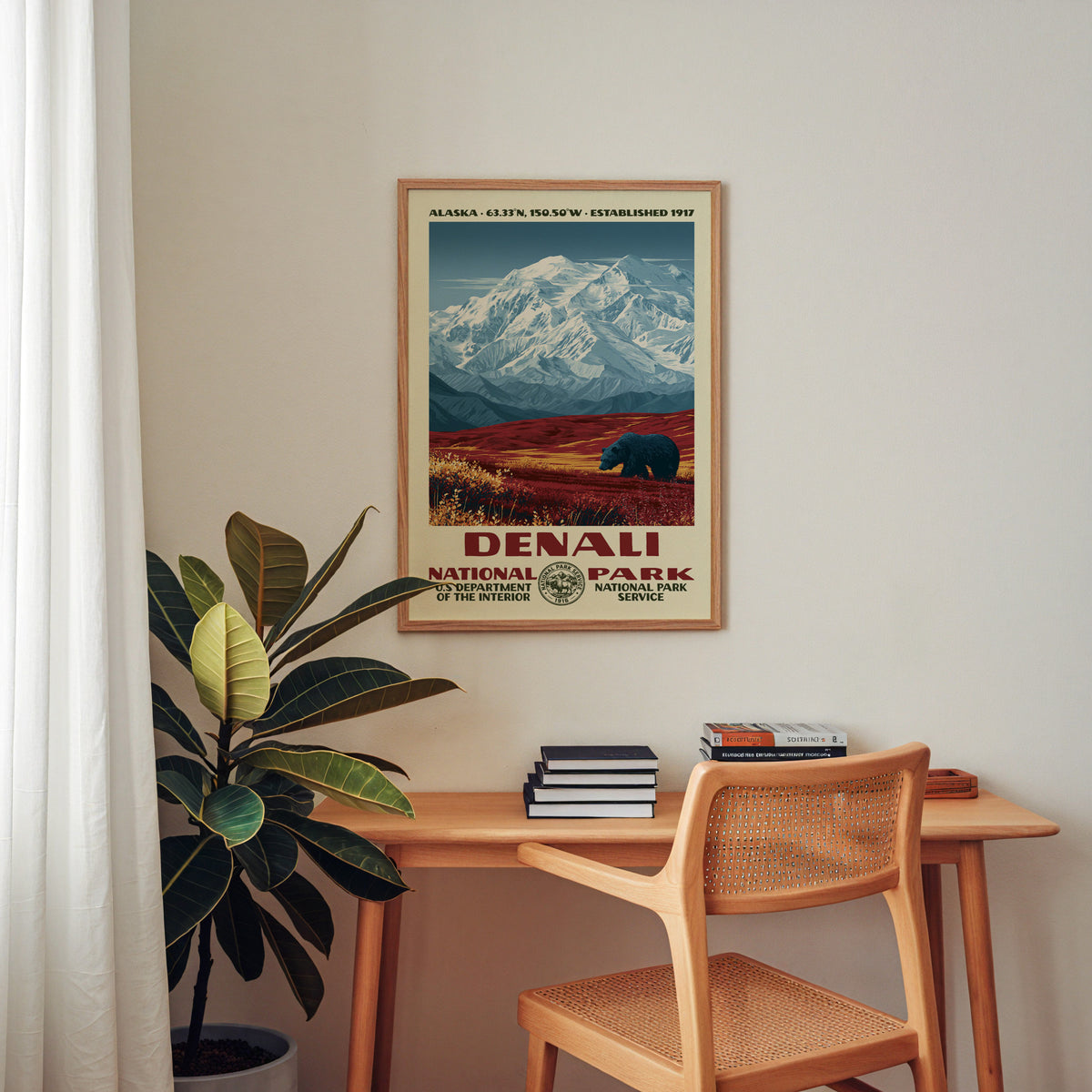 Denali National Park retro poster framed above a wooden home office desk with books and plants