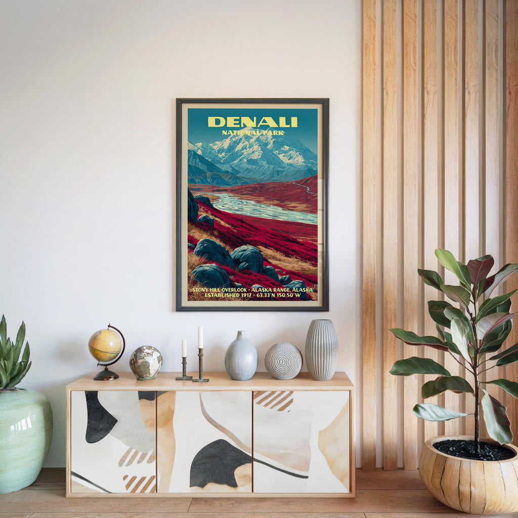 Denali National Park poster in a black frame above a light wood sideboard by a slatted wall panel