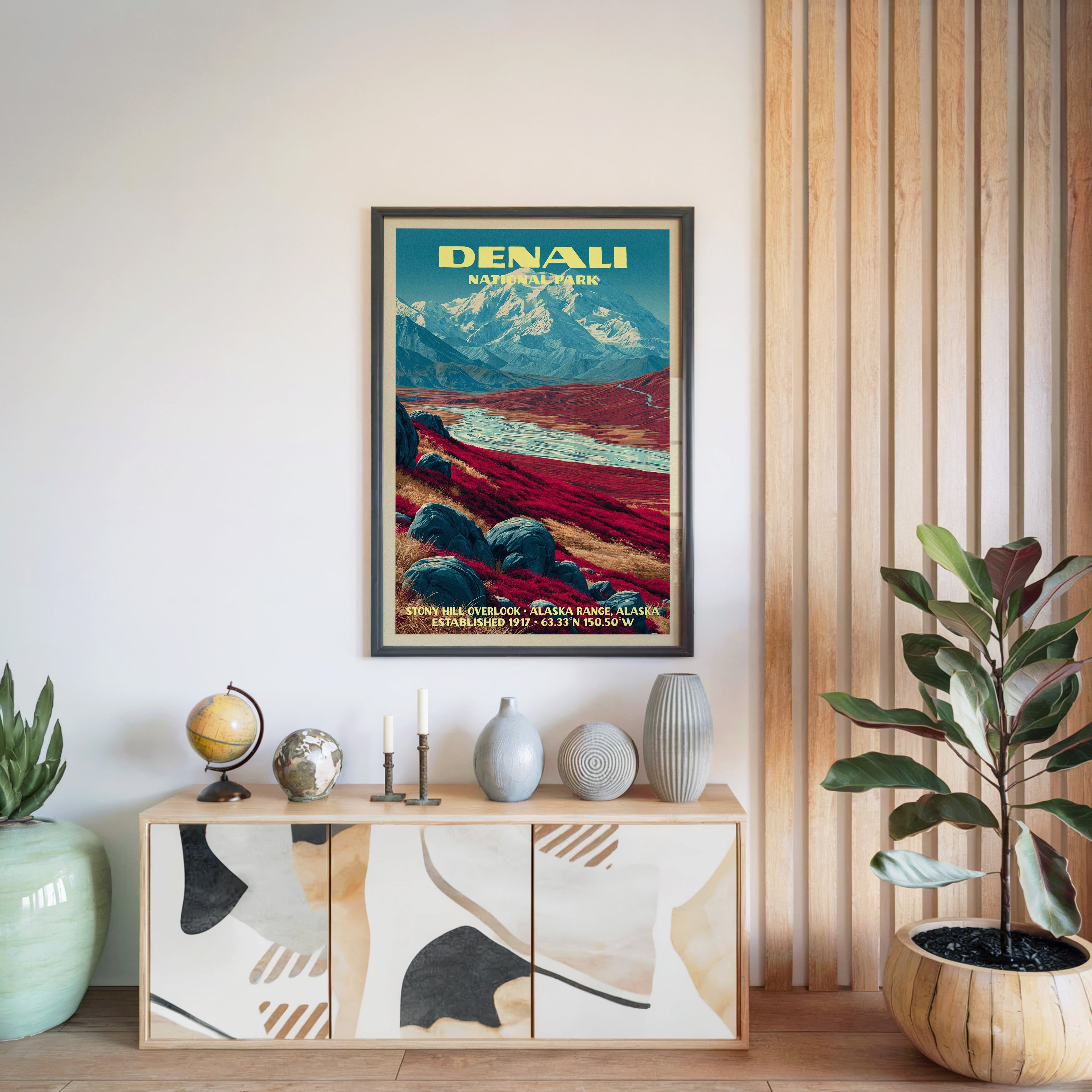 Denali National Park poster in a black frame above a light wood sideboard by a slatted wall panel