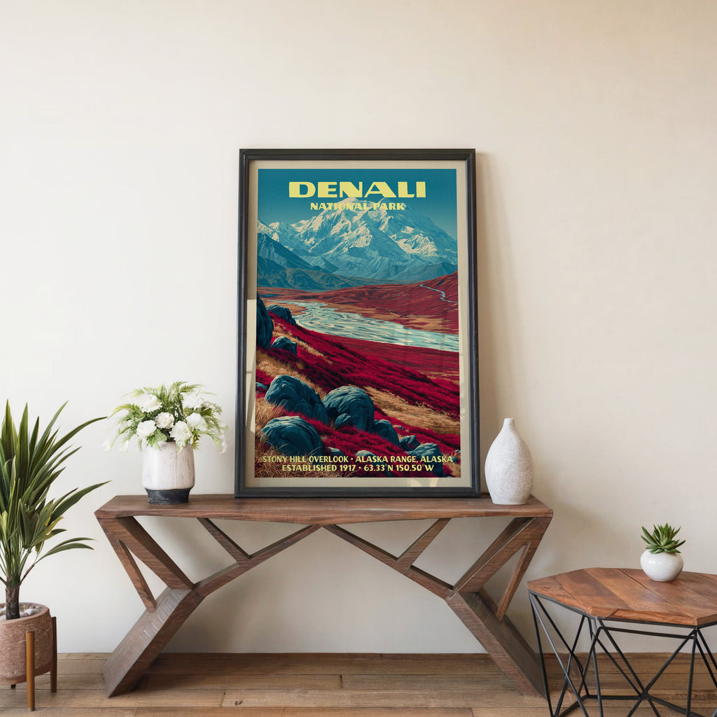 Denali Stony Hill Overlook wall art in black, leaning on a walnut console with white anemones and a vase