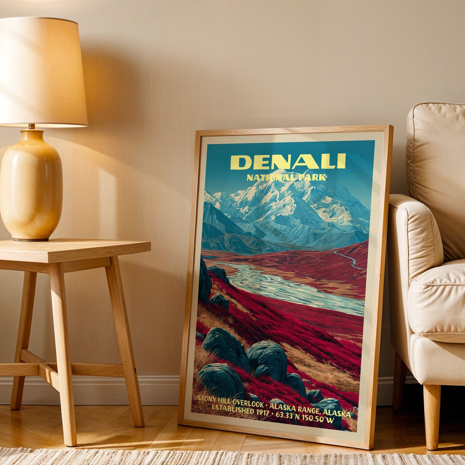 Denali Stony Hill Overlook wall art in oak, leaning by an armchair and a side table with an ochre lamp
