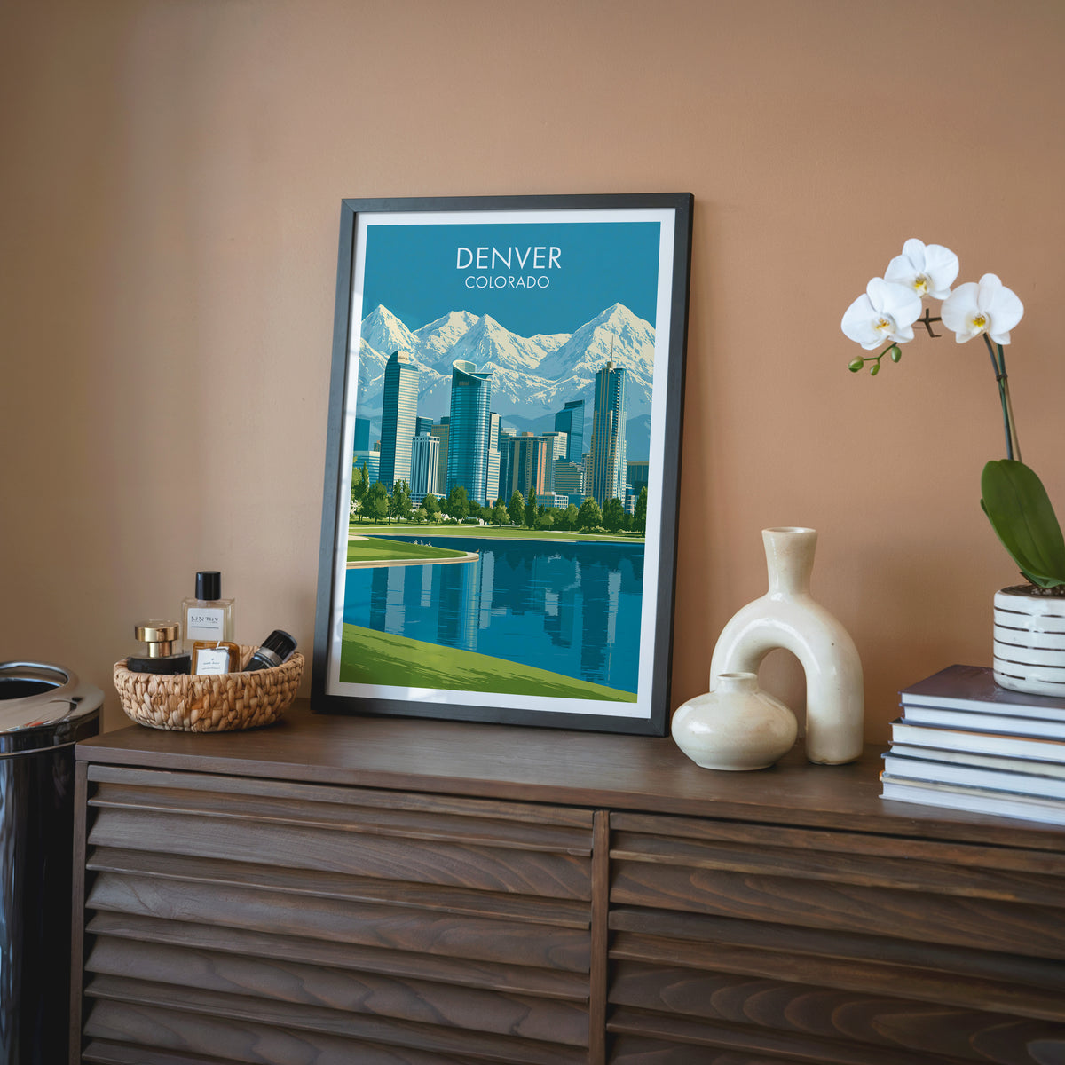 Front Range mountains wall art in a black frame on a walnut sideboard against a terracotta wall