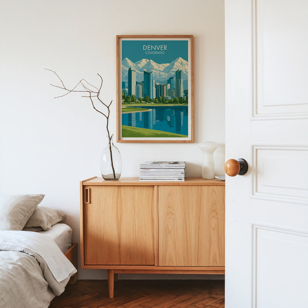 Denver Colorado canvas art in an oak frame on a sideboard with dried branches in a glass vase