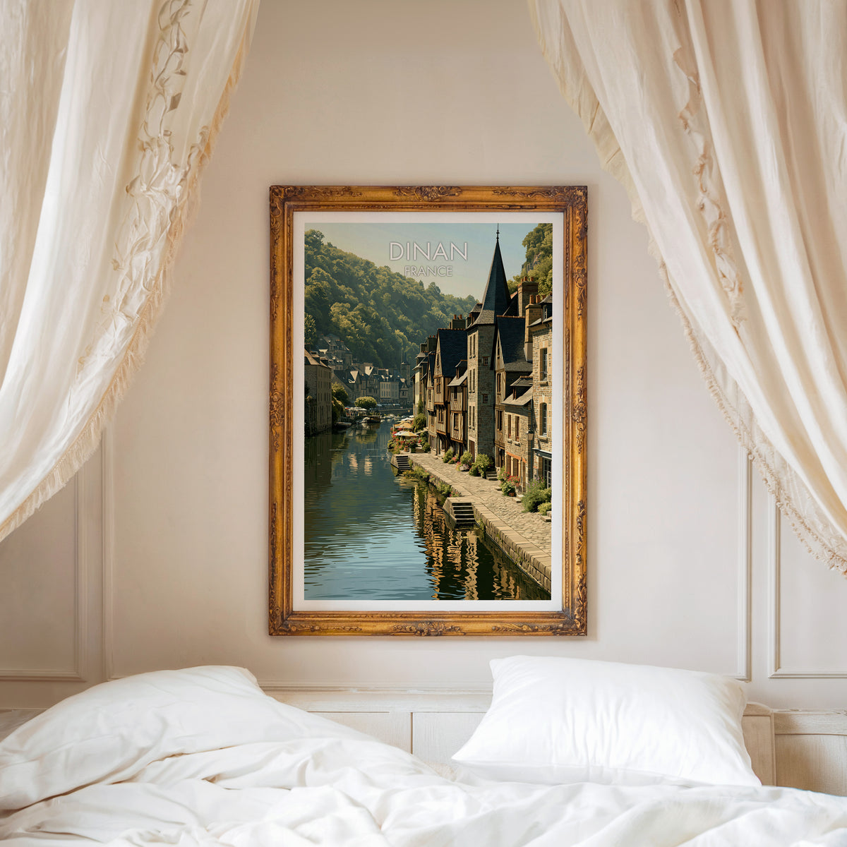 Dinan travel poster, ornate gold frame above a white bed with linen canopy curtains