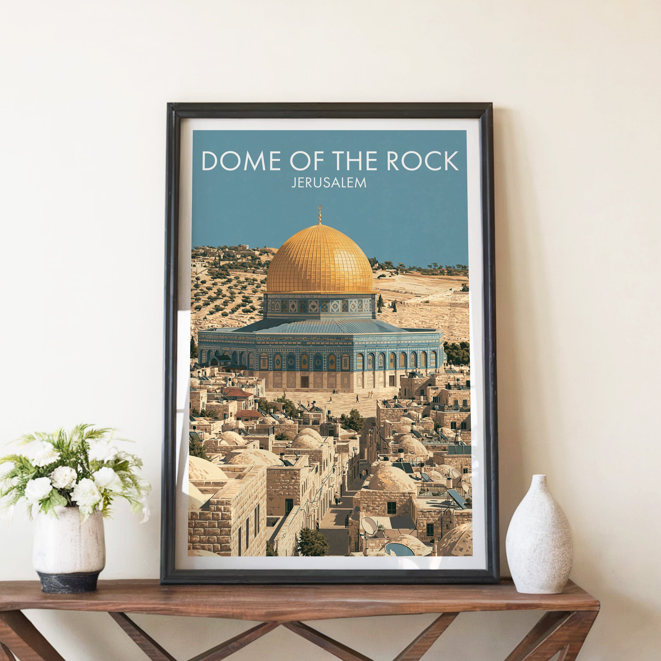 Dome of the Rock Jerusalem travel poster in a black frame on a wooden console table with white flowers