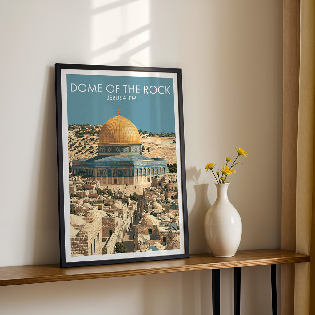 Black framed Dome of the Rock Jerusalem print on a narrow hallway console in sunlight, styled with yellow flowers