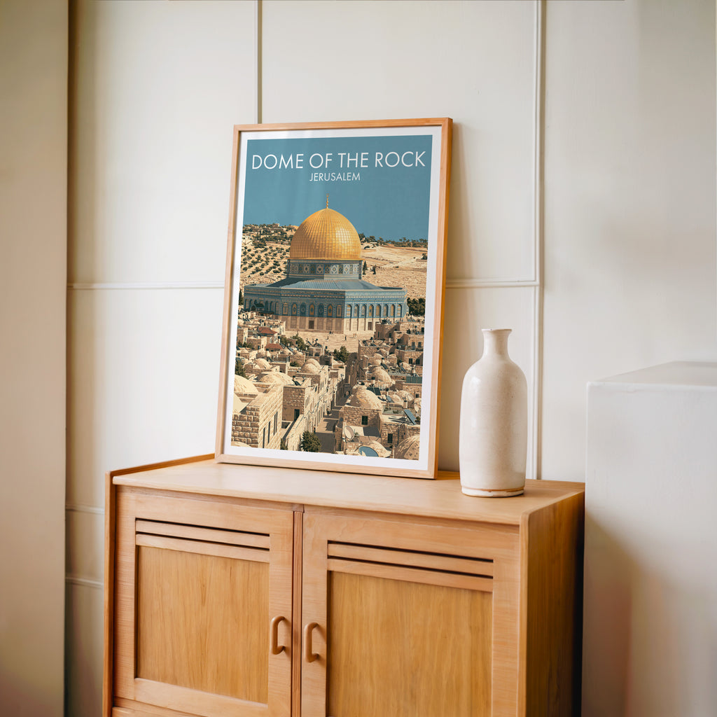 Small Dome of the Rock Jerusalem travel poster in an oak frame on a mid-century sideboard with a ceramic vase