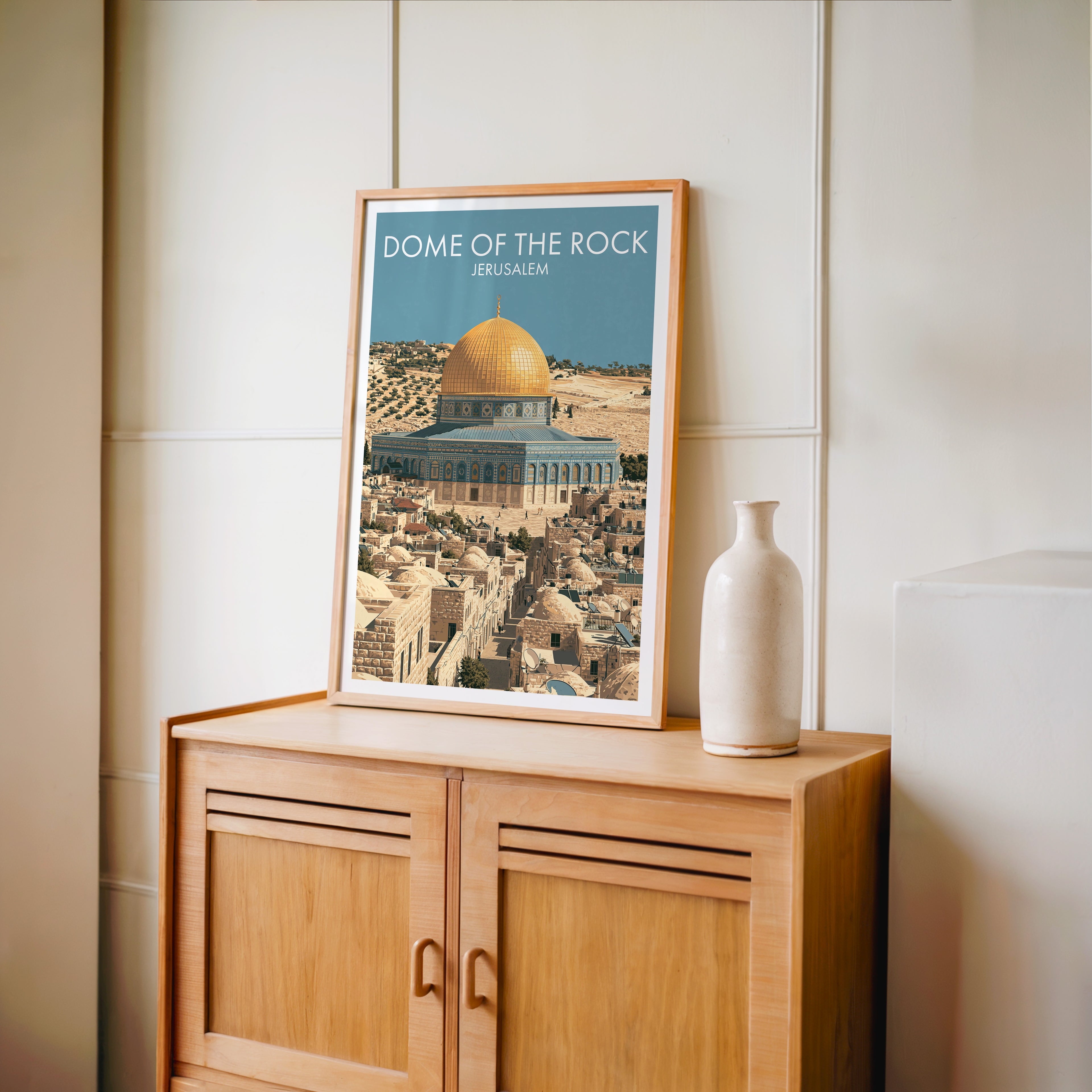 Small Dome of the Rock Jerusalem travel poster in an oak frame on a mid-century sideboard with a ceramic vase