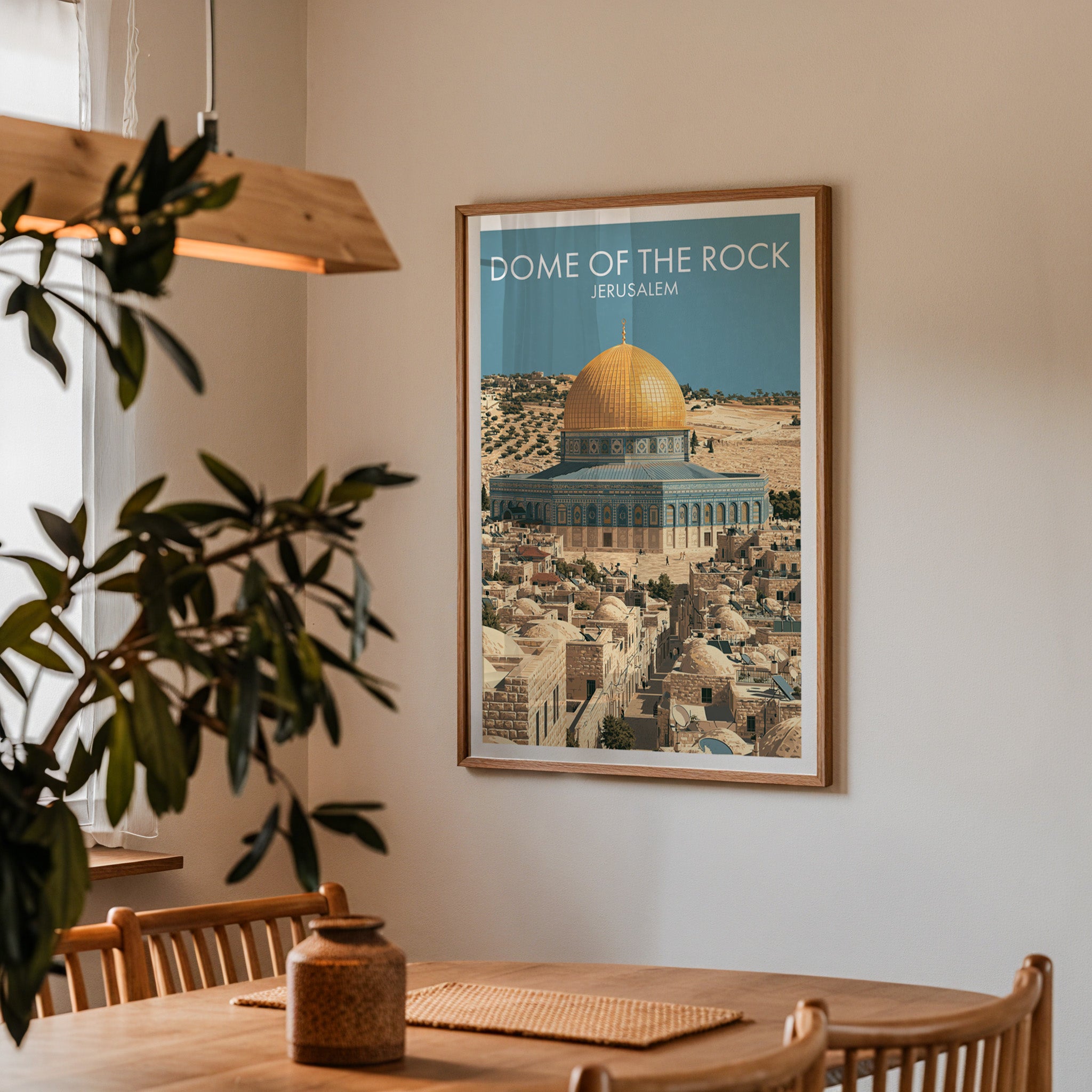 Framed Dome of the Rock Jerusalem print on a dining room wall above an oak table in warm afternoon light