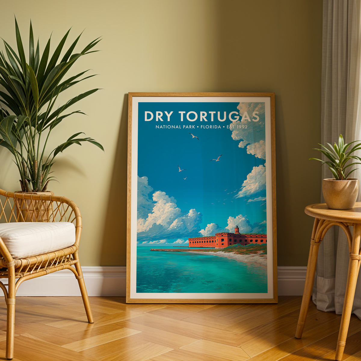 Dry Tortugas National Park mid-century modern art print leaning against an olive-green wall beside a rattan chair and potted palm — reading nook wall art