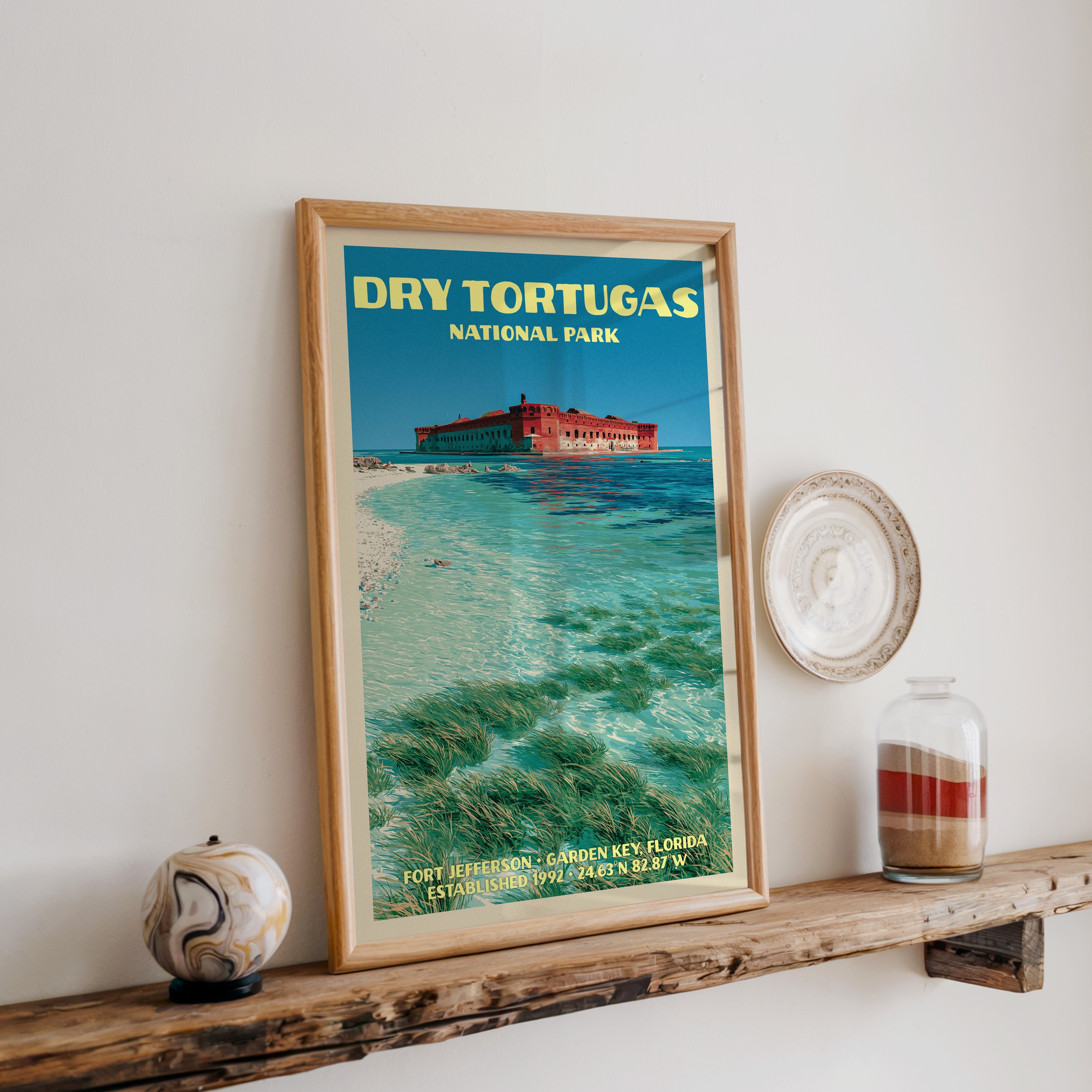 Dry Tortugas Fort Jefferson print in oak, leaning on a reclaimed wood ledge with a marbled sphere and sand jar