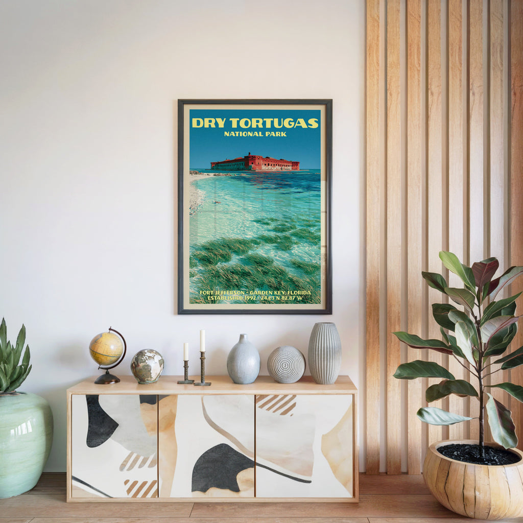 Dry Tortugas National Park poster in a black frame above a light wood sideboard by a slatted wall panel
