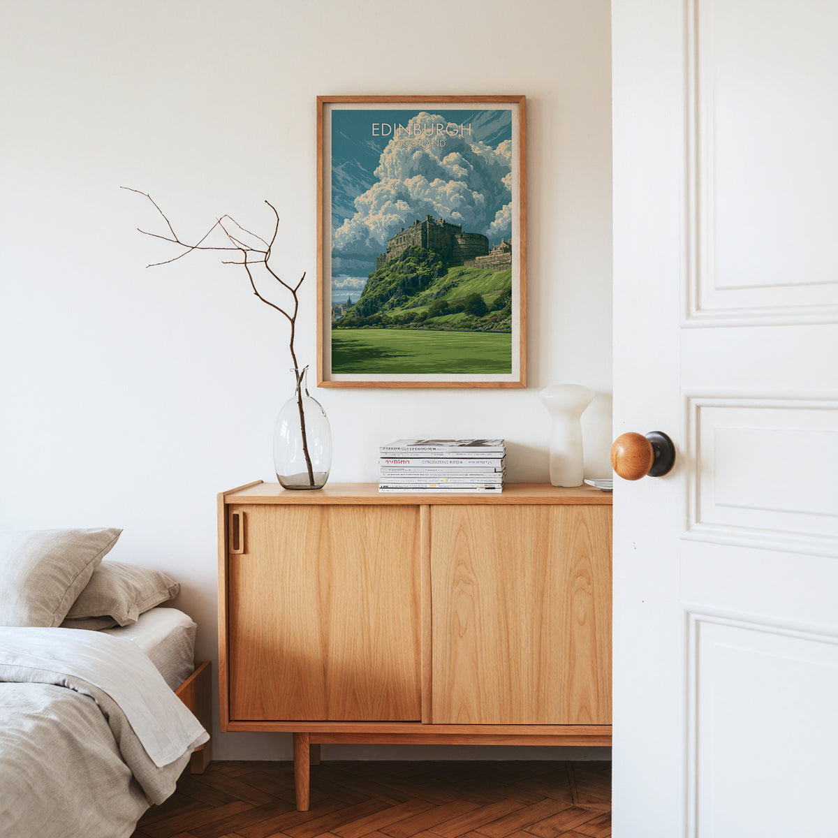Edinburgh Castle crag print, oak frame above a light oak sideboard with bare branches in a glass vase