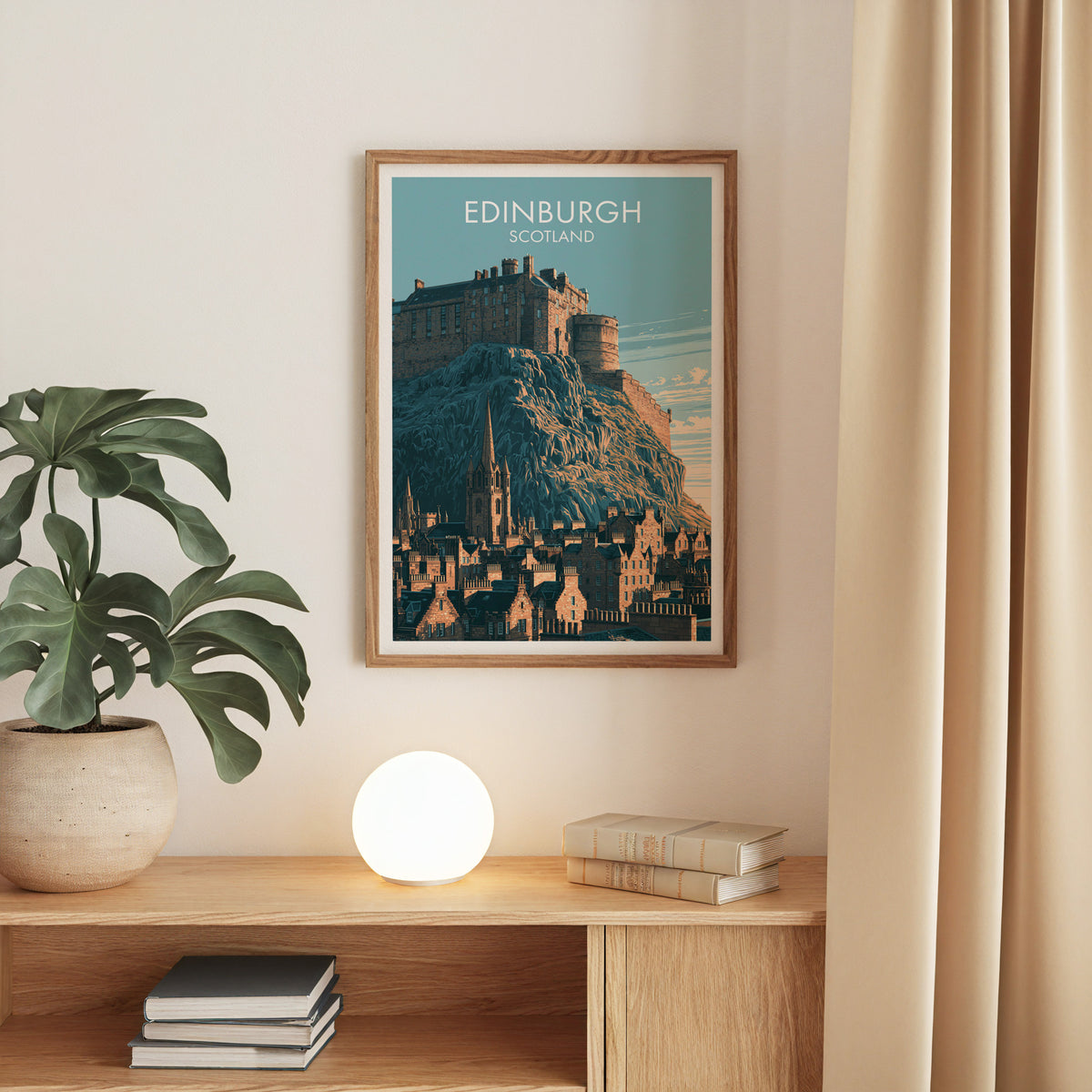 Edinburgh Castle poster in oak above an oak console with a monstera, a round globe lamp and stacked books
