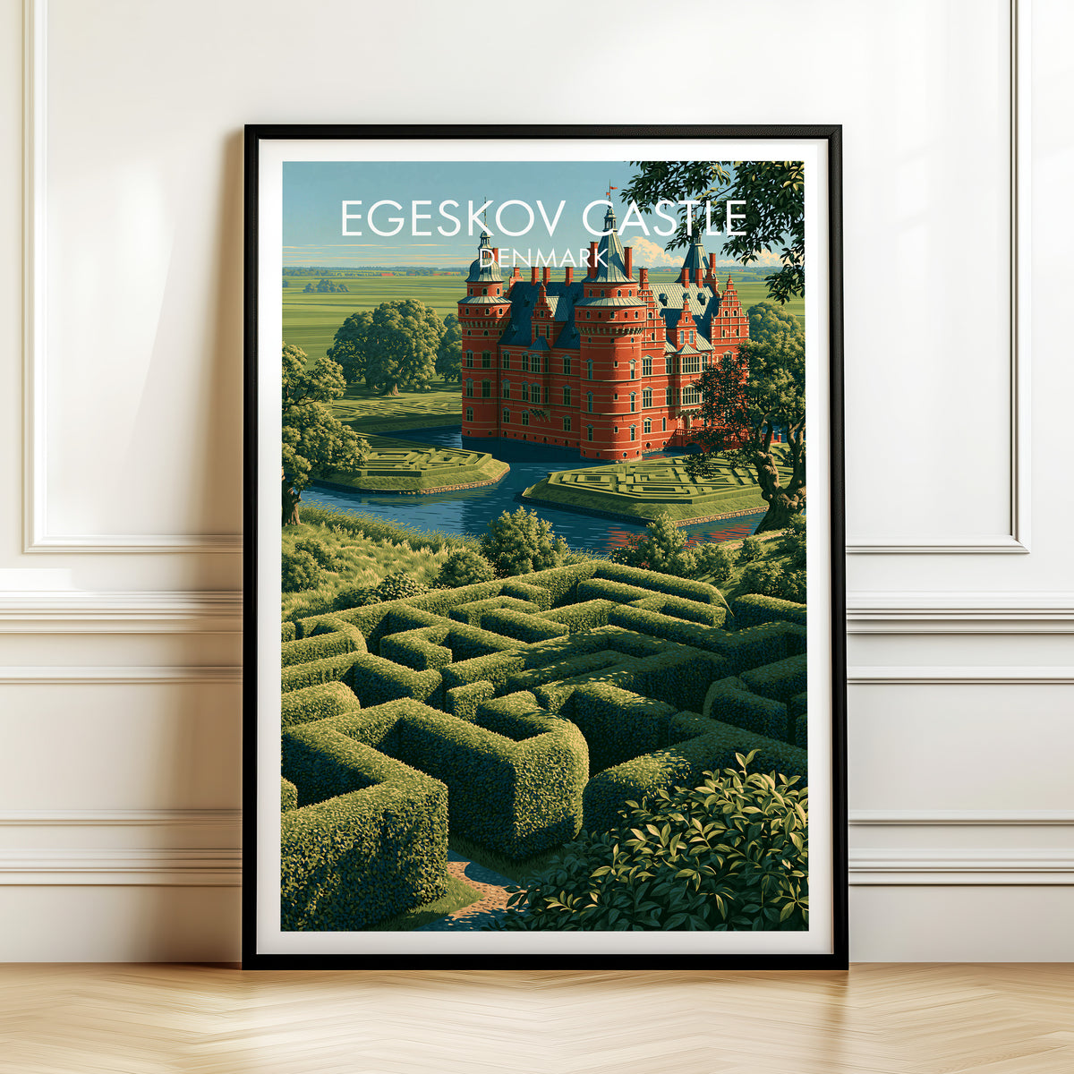 Egeskov hedge maze print, black frame leaning on a white panelled wall above a herringbone floor