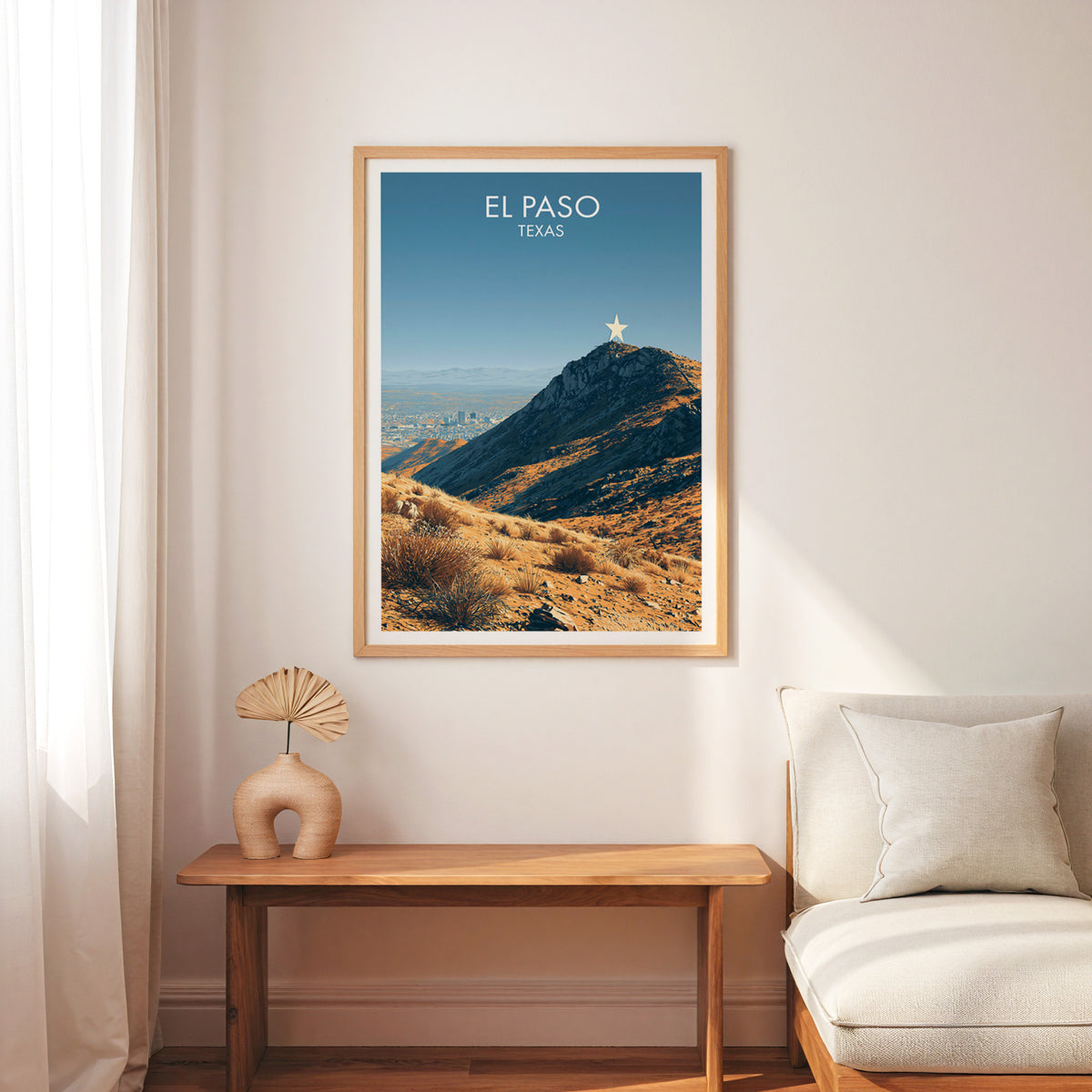 El Paso Texas wall art in an oak frame above a slim wood bench and a cream armchair